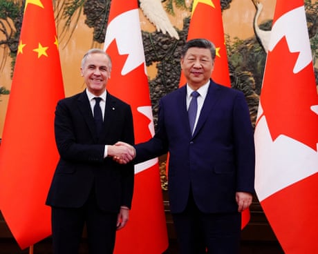 Canadian leader Mark Carney shakes hands with Xi Jinping in front of flags