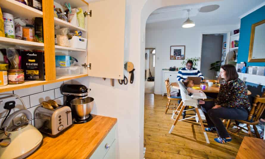 Jonathan & Jess Daly with baby Robin at home in Norwich, UK. Image shows food in cupboards.