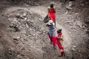 Suhani, 15, Suman, 21, and Radhika, 15, descend into the pit, as clouds of noxious fumes spew from the cracked earth.