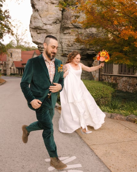 A man and woman holding hands and leaping