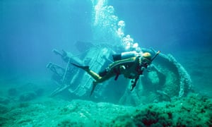 scuba diver with shipwreck underwater in Gozo Malta