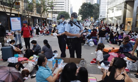 Police patrol central Hong Kong to tell women ‘helpers’ enjoying a day off to maintain social distancing.