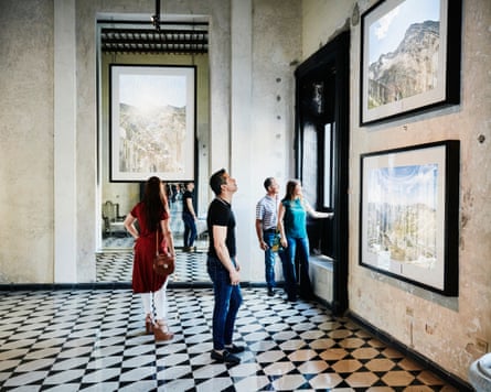 Two couples admiring artwork while touring museum during vacation