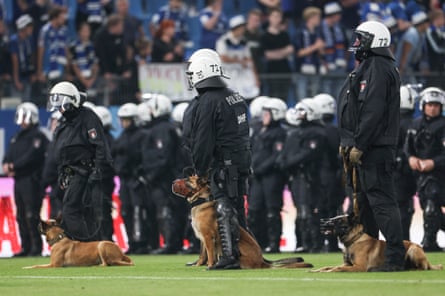 Riot police on the pitch after the Bundesliga playoff second leg between Hamburger SV and VfB Stuttgart in June.