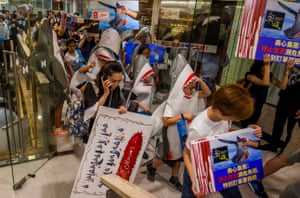 Members of environmental group WildAid protest outside a Maxim’s restaurant in Jardine House, Hong Kong