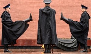 Russian honour guards stand on duty under the heavy rain at the Tomb of the Unknown Soldier by the Kremlin wall in downtown Moscow on 31 May 2020, during a strict lockdown in Russia to stop the spread of the Covid-19, (the novel coronavirus).