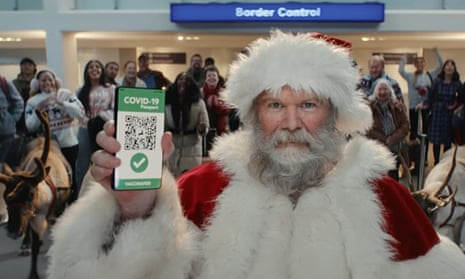 A scene from Tesco's Christmas ad featuring Father Christmas presenting his Covid pass at border control
