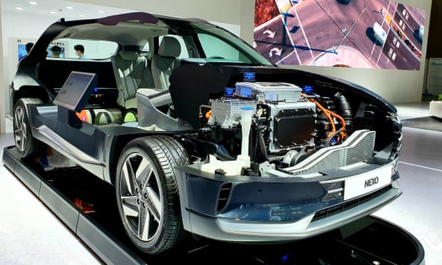 A hydrogen fuel cell and motor on display in a cutaway Hyundai NEXO SUV.