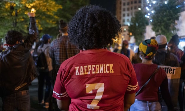 A woman wears a Colin Kaepernick jersey during a George Floyd protest near the White House on Wednesday in the nation’s capital.