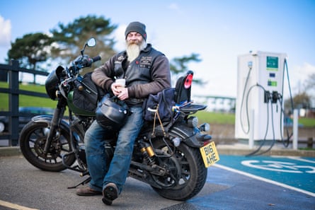 Alan Harrison leans on his bike and smiles
