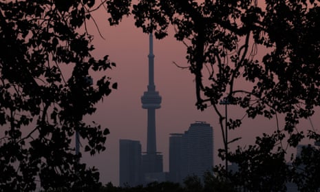 Smoke from forest fires in Northern Ontario and in Quebec contribute to pink hazy sunset in the city from the Cherry Beach over Toronto. June 6, 2023.