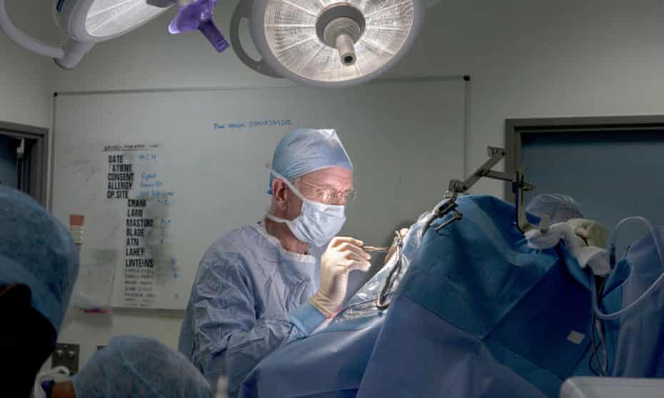 Dr Henry Marsh operating to remove a tumor from the brain of a young woman at St George’s Hospital in London, 2014.