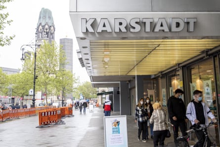 People queue outside Karstadt shopping centre during the coronavirus crisis in Berlin.