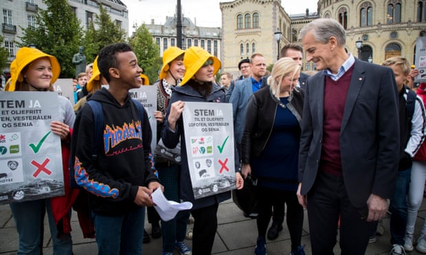 Norway’s Labour party leader, Jonas Gahr Støre, right, talks with environmentalists at an campaign event in Oslo.