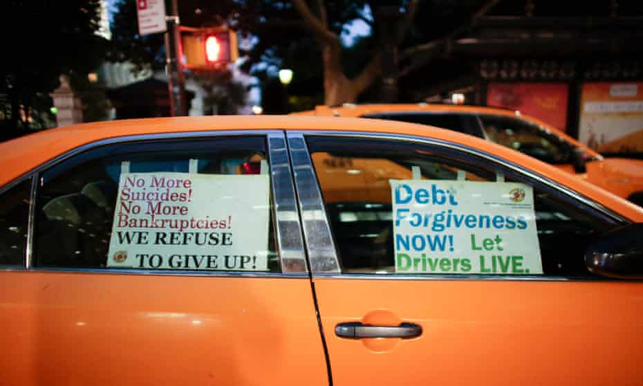 Placards are displayed in the windows of a yellow cab as drivers attend a rally outside City Hall in New York City on 20 October 2021. 