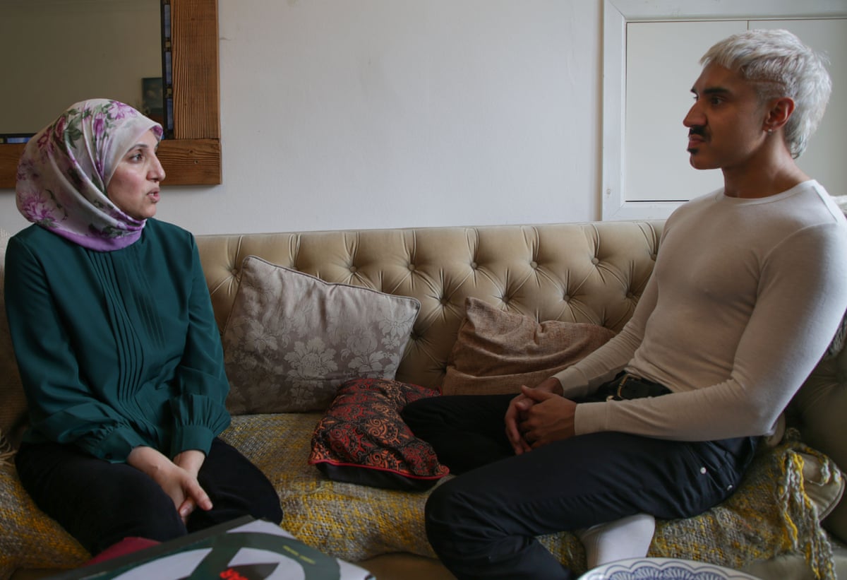 She and Azhar sit across from each other on a sofa