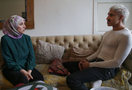 She and Azhar sit across from each other on a sofa