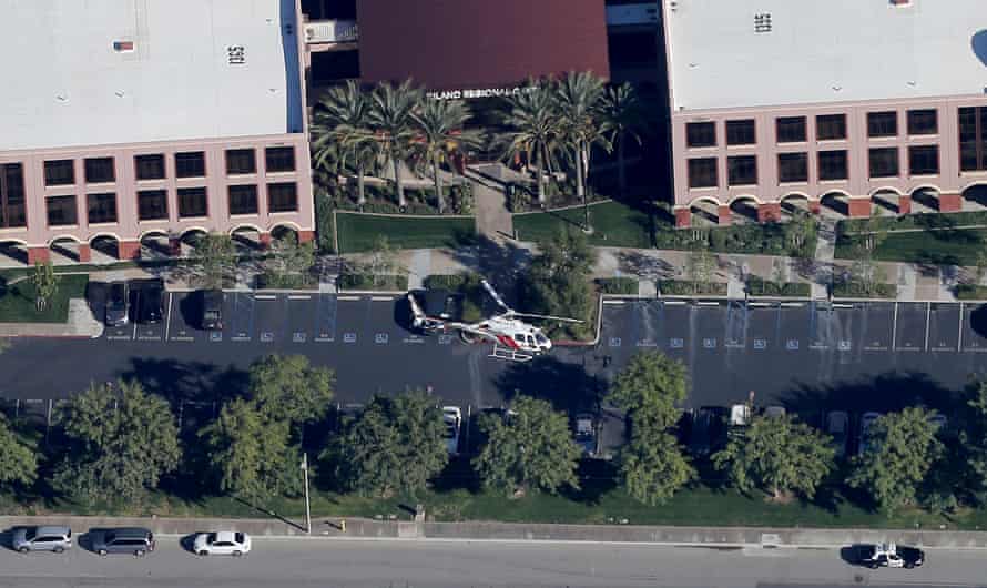 A police helicopter hovers around the Inland Regional Center in San Bernardino