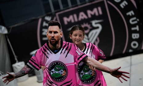 An Inter Miami fan with a cardboard cutout of Lionel Messi