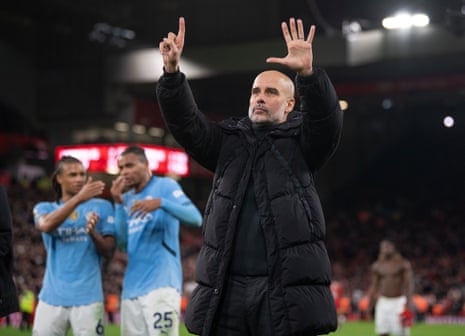 Manchester City manager Pep Guardiola holds up six fingers to Liverpool fans after his side lose at Anfield