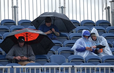 Spectators shelter from the rain during the final day of the Aberdeen Ladies Scottish Open at Gullane golf course.