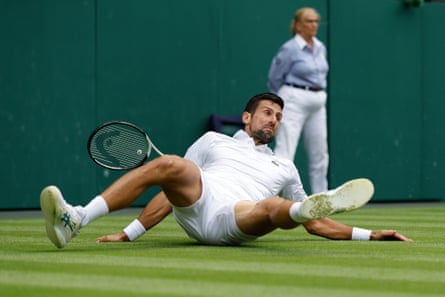 Novak Djokovic falls to the ground during the men’s final