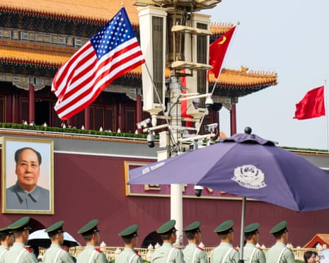 Paramilitary police line up in front of Tiananmen Gate near US and Chinese flags and a portrait of Mao Zedong in Beijing on Wednesday.