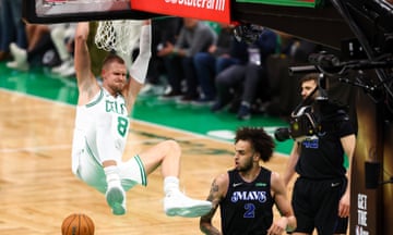 The Celtics’ Kristaps Porziņģis dunks over the Mavericks’ Dereck Lively II during the first quarter of Thursday’s Game 1 of the NBA finals.