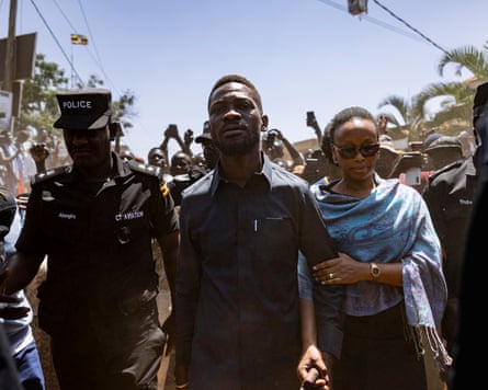 Bobi Wine arrives at a polling station in Magere village, Kampala, with his wife, Barbie Itungo Kyagulanyi