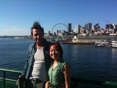 The pair in front of water and the city skyline