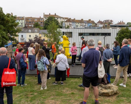 A group of people looking at a sculpture