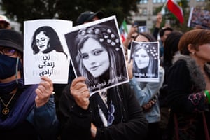 Washington DC, US: women display portraits of Mahsa Amini at her vigil, after she died last week in custody of Iran’s morality police