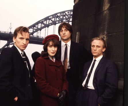 Three men and a woman standing front of the Tyne Bridge.