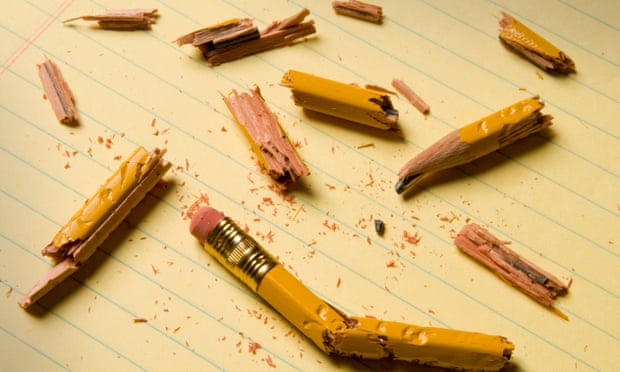Shattered pencil fragments on a yellow legal pad, perhaps symbolizing writer’s block