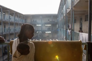 A girl with a child on her back, who are two of thousands to seek shelter in a secondary school at Hadnet.