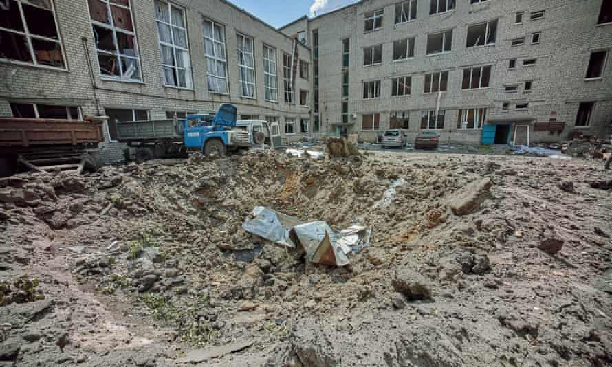 A shelling hole near a college following a Russian rocket hit a residential area of Kharkiv, Ukraine.