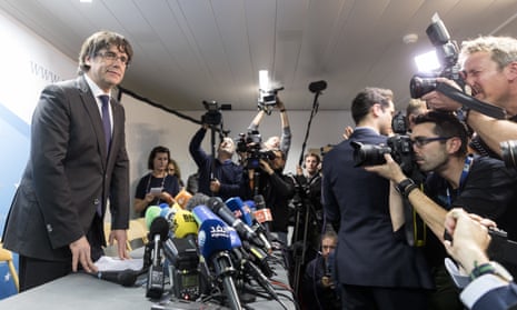 Charles Puigdemont (left) gives a statement during a press conference in Brussels.