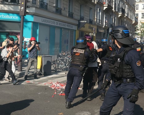 French police detain protestors in Paris during a day of nationwide strikes and protests.