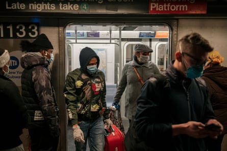 Commuters wear face masks as they exit a subway train on April 17, 2020 in New York City. Following a new order from Governor Andrew Cuomo that New Yorkers must wear face coverings whenever social distancing is not possible, the measure is the latest in a series of communal steps taken to stop the spread of the deadly coronavirus (COVID-19).