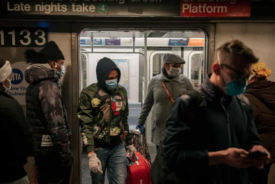 Commuters wear face masks as they exit a subway train on April 17, 2020 in New York City. Following a new order from Governor Andrew Cuomo that New Yorkers must wear face coverings whenever social distancing is not possible, the measure is the latest in a series of communal steps taken to stop the spread of the deadly coronavirus (COVID-19).