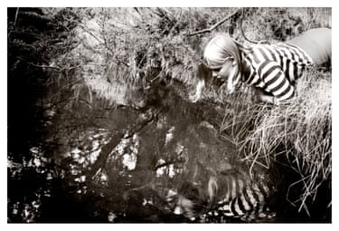A photo of Celia gazing into a river.