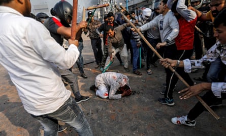 Mohammad Zubair, 37, is beaten by a Hindu mob in one of the most shocking images from a week of violence in Delhi.