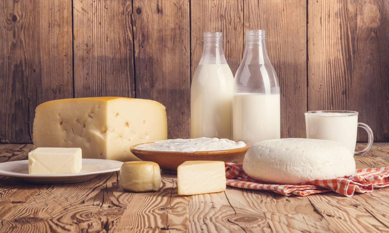 Varied dairy products against a wood-like background