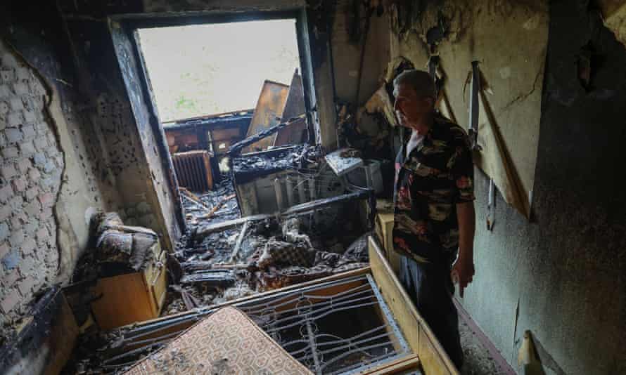 Gennady Goncharov, 67, surveys the damage of his apartment following previous night’s shelling in Donetsk