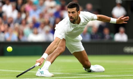 Novak Djokovic stretches to reach the ball against Jannik Sinner