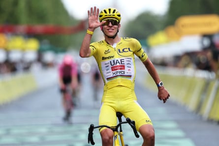 Tadej Pogacar celebrates his overall victory as he crosses the finish line of the 21st stage of the 113th edition of the Tour de France