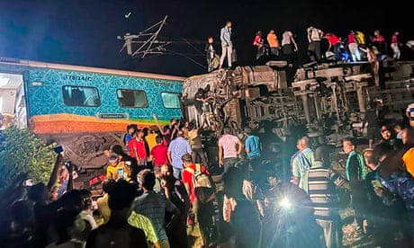 Rescuers work at the site of passenger trains that derailed