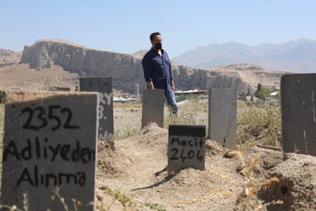Lawyer Mahmut Kaçan among the graves of nameless refugees, in Van, Turkey.