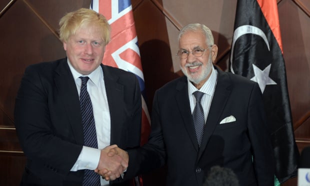 Boris Johnson, the British foreign secretary, shakes hands with his Libyan counterpart, Mohamed Taha Siala, in Tripoli.