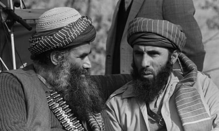 Gulbuddin Hekmatyar (right) confers with an Afghan guerrilla leader in Peshawar in January 1987.